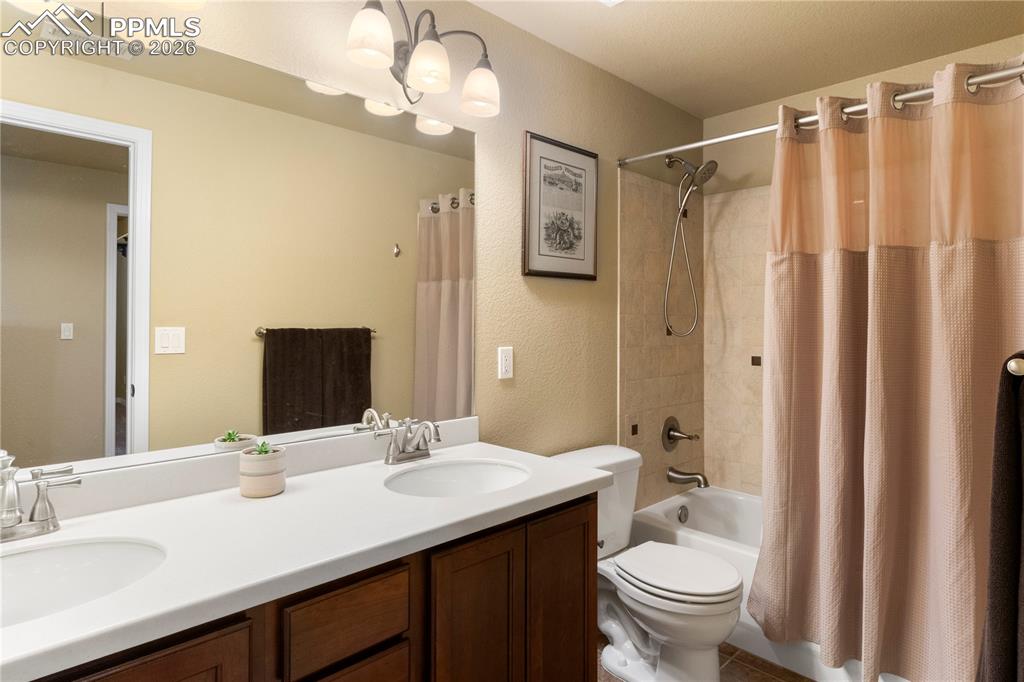 Image 29 of 43: Basement full bath with double vanity. 