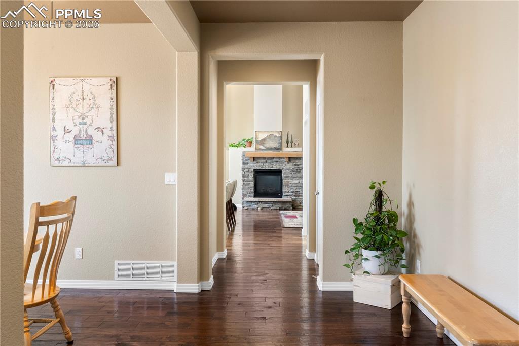 Image 3 of 43: Spacious entry with dark hand scraped wood flooring.