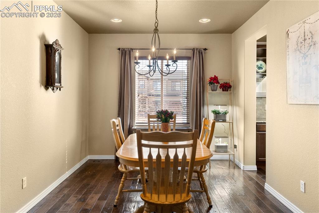 Image 5 of 43: Formal dining room with wood flooring open to butlers pantry for easy enter