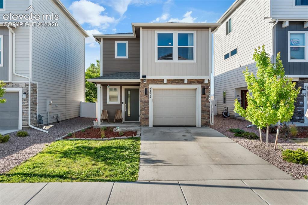 Image 1 of 38: Two-story residence featuring a contemporary exterior with siding and stone