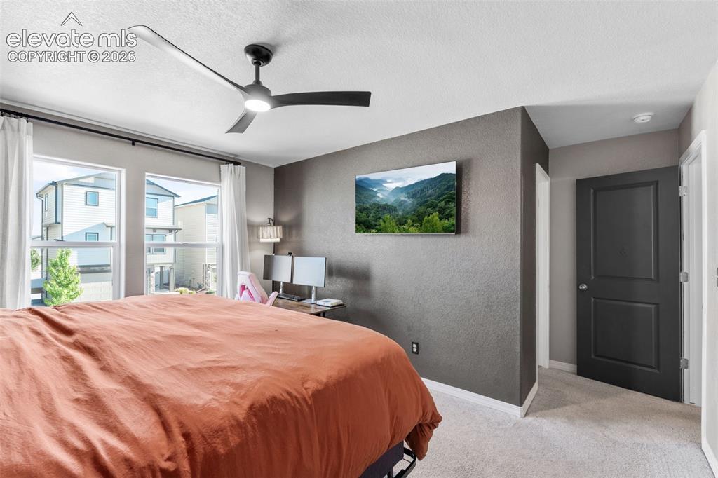 Image 18 of 38: Bedroom featuring a contemporary ceiling fan with integrated lighting, dual