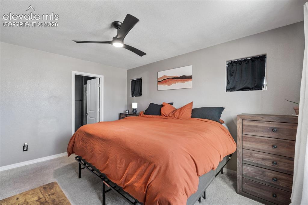 Image 19 of 38: Bedroom featuring a modern ceiling fan with integrated lighting, light gray