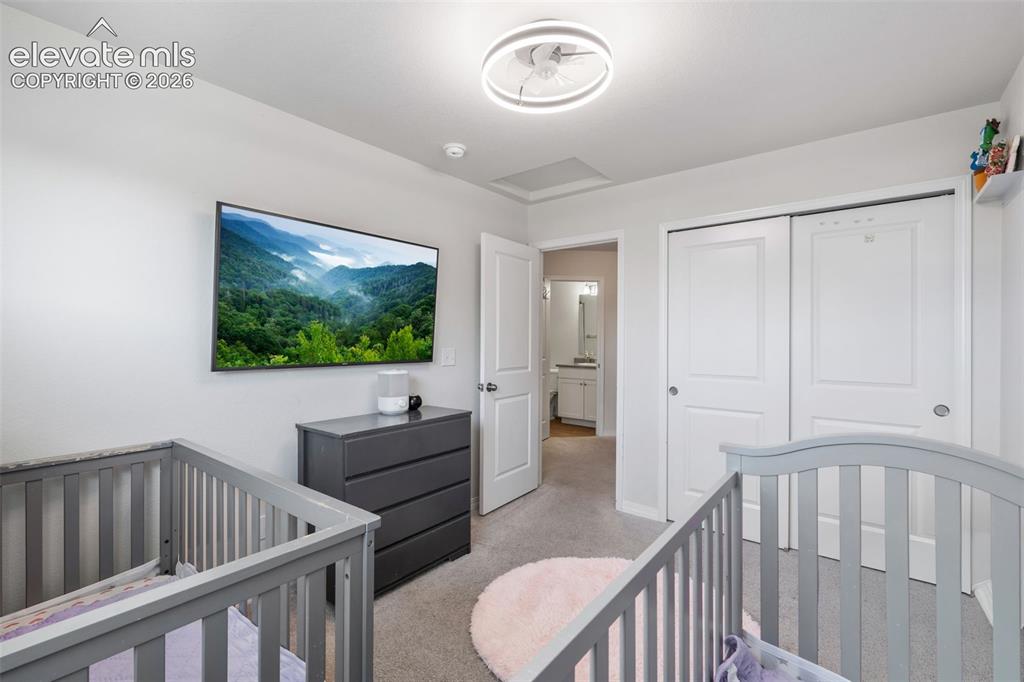 Image 27 of 38: Bright interior room featuring light gray walls, carpet flooring, a modern 