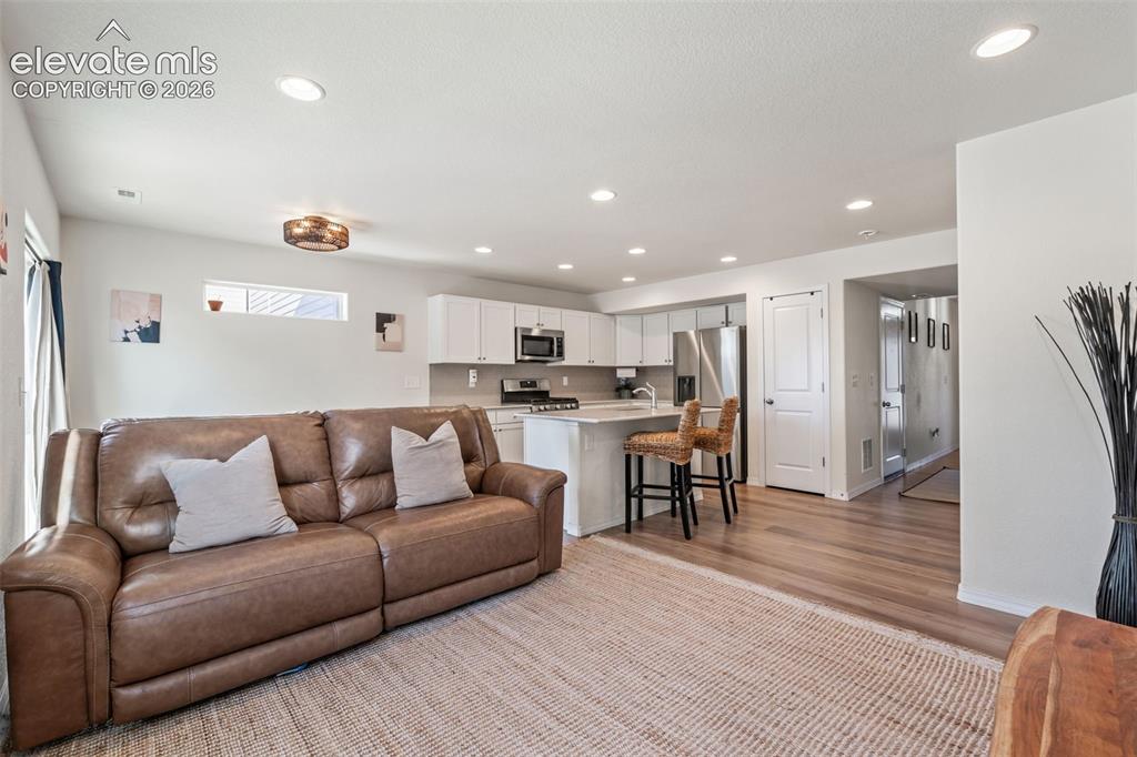 Image 3 of 38: Open concept living space featuring recessed lighting and wood-finish floor