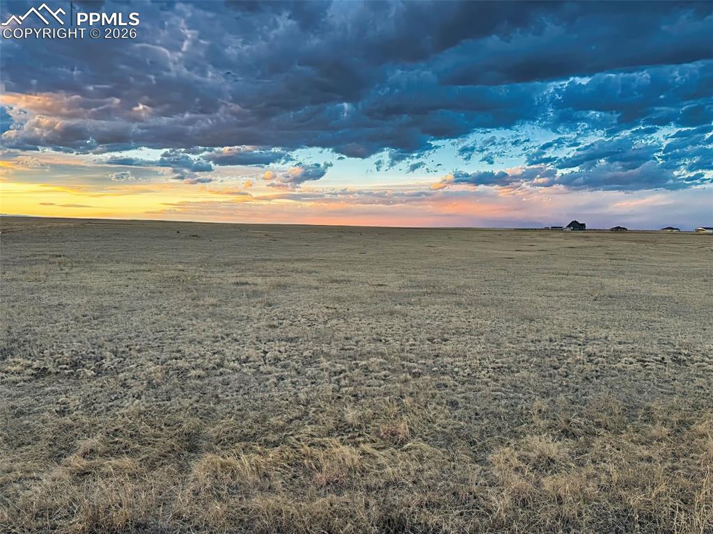 Image 13 of 13: Evening Sky Over Open Land – Expansive prairie views beneath dramatic eveni