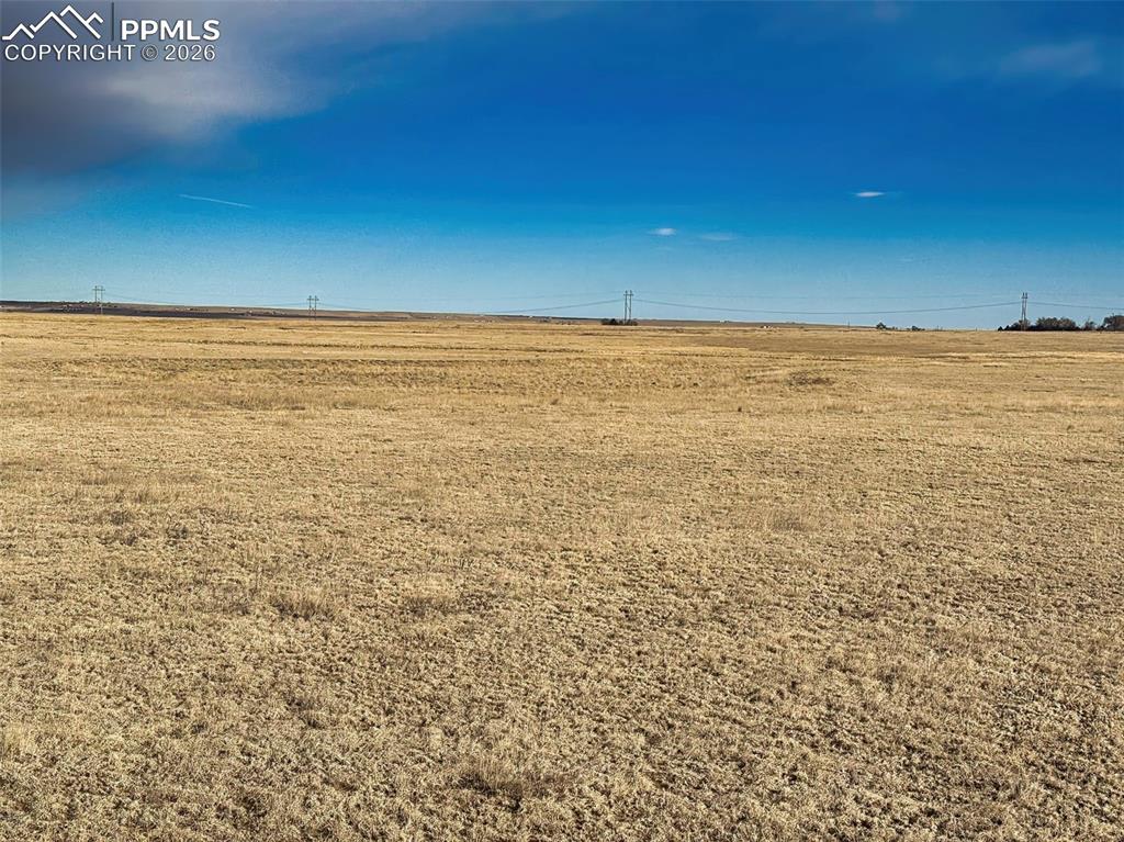 Image 3 of 13: Big Sky Panorama – Sweeping plains under vibrant blue skies, highlighting t