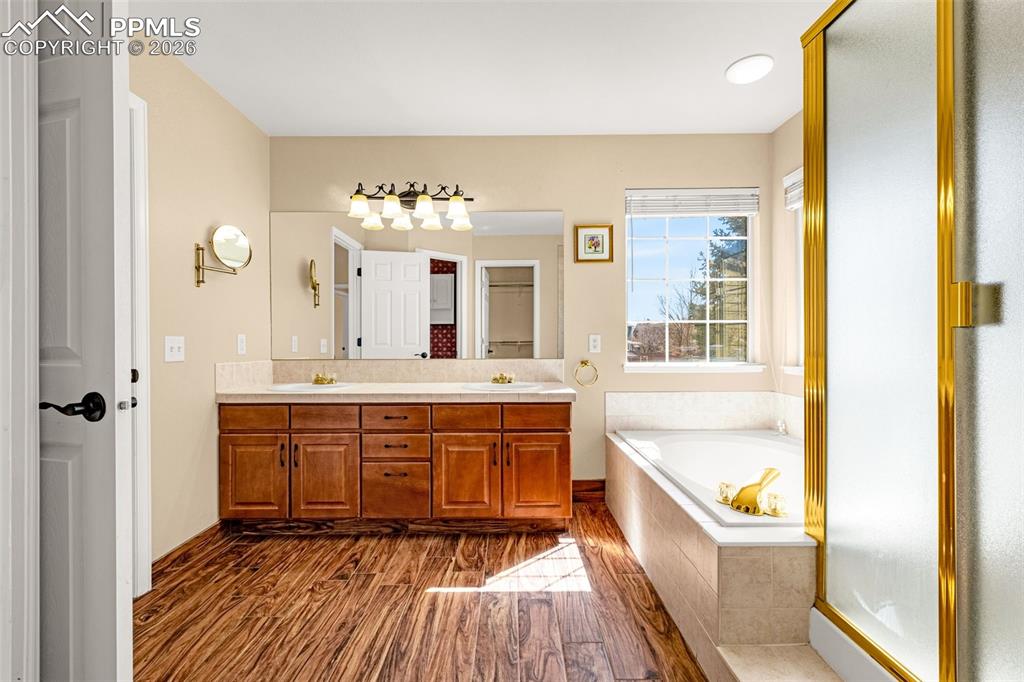 Image 13 of 39: Wood look tile flooring sets off the natural cabinetry features