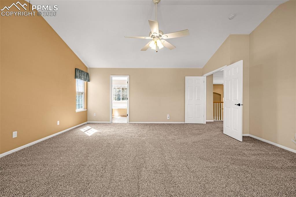 Image 15 of 39: French doors open to an incrediblely spacious master suite