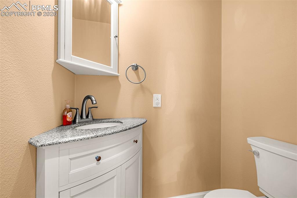 Image 22 of 39: A convenient half bath off the living room/front hallway area