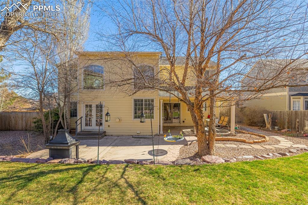 Image 29 of 39: Well maintained lawn with xeroscape accents; patio has built in fireplace
