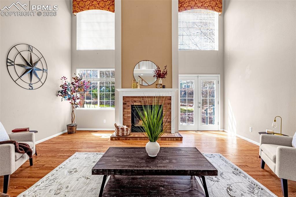 Image 3 of 39: Spacious and inviting living room complete with fireplace, vaulted ceiling,