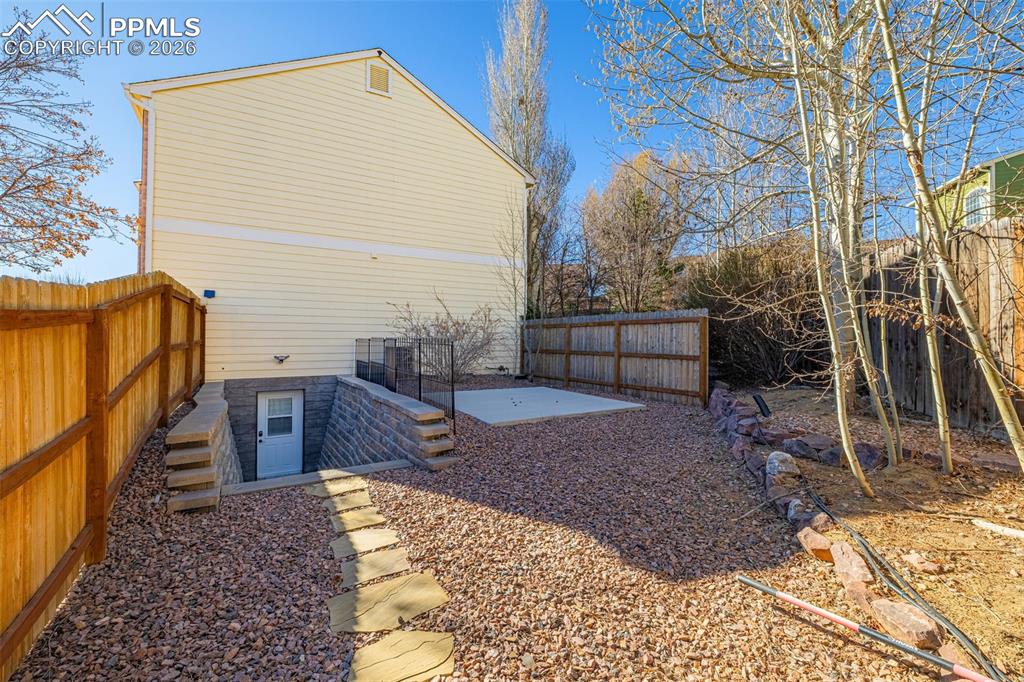 Image 31 of 39: Basement level mother-in-law casita offers a private entrance, with patio a