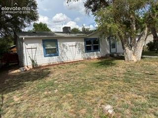 Image 2 of 9: White siding exterior with blue window trim and an asphalt shingle roof
