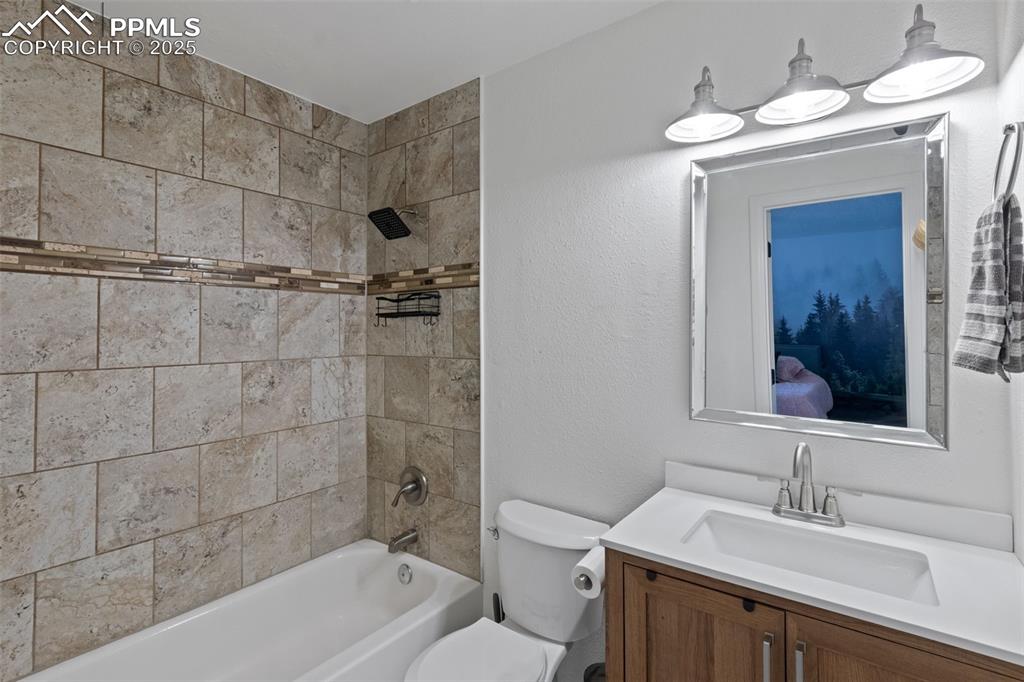 Image 13 of 24: Full updated bath with vanity and tub / shower combination.