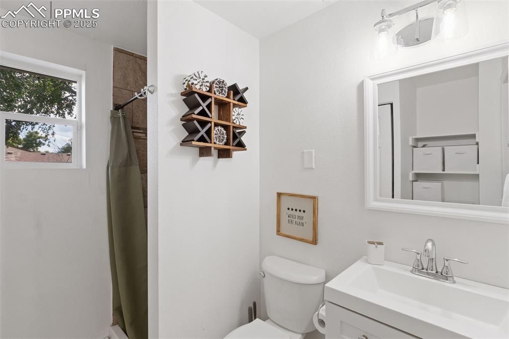 Image 16 of 24: Downstairs bathroom featuring updated vanity and shower.