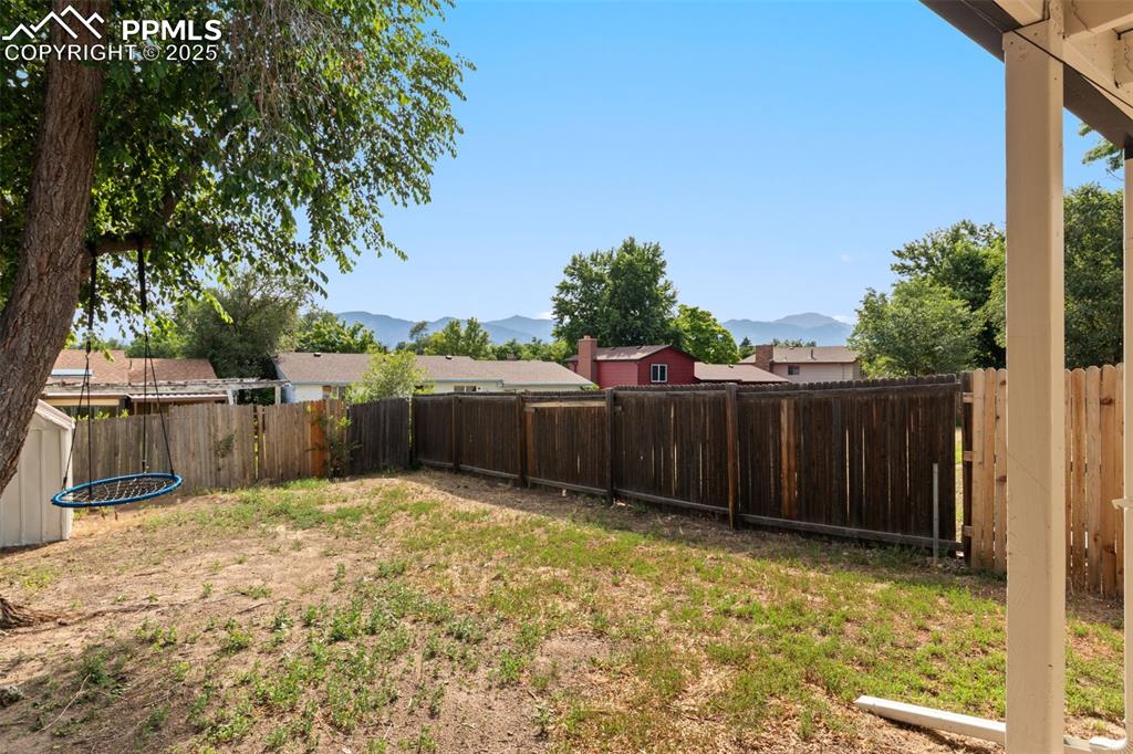 Image 22 of 24: Fenced backyard featuring a mountain view