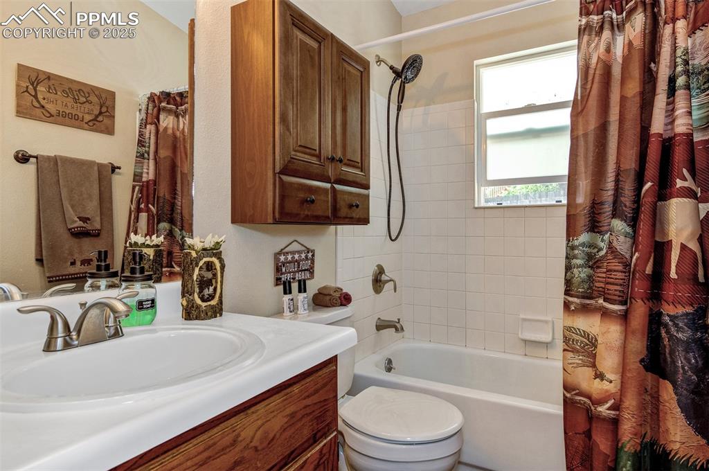 Image 12 of 27: Full bath with shower / bath combo and vanity