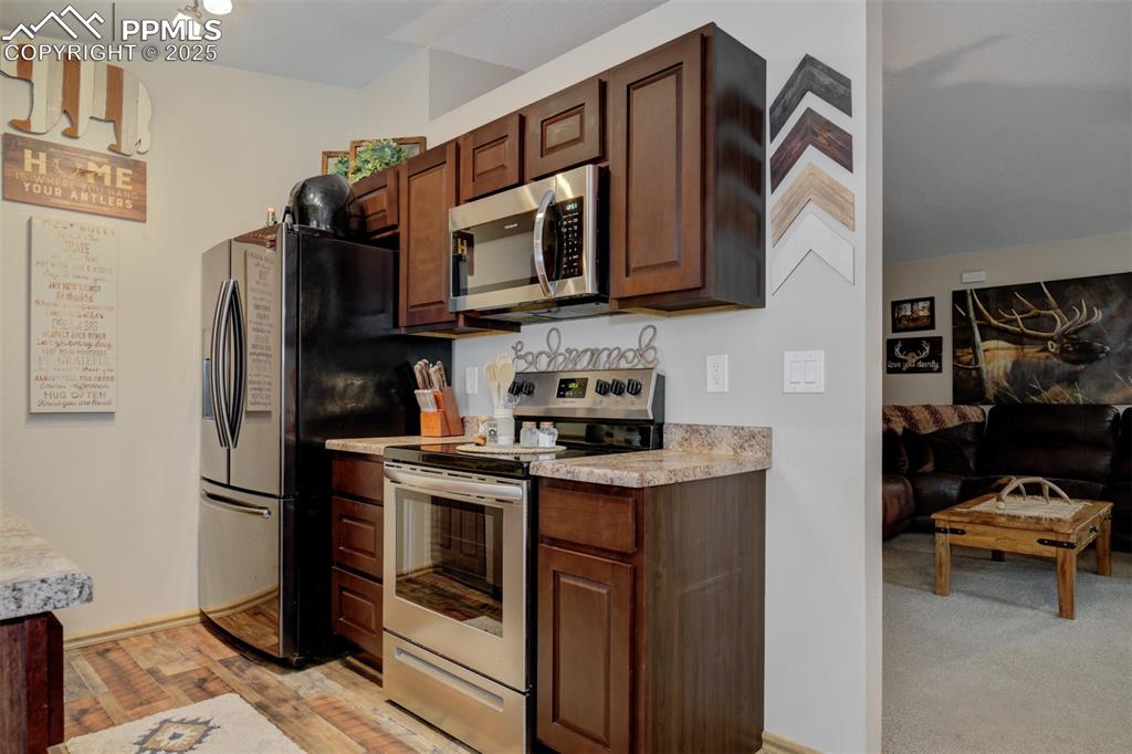 Image 8 of 27: Kitchen featuring newwer appliances with stainless steel finishes
