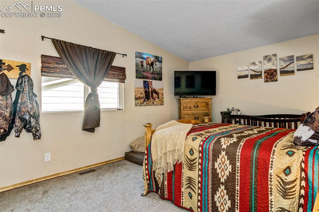 Image 9 of 27: Primary bedroom on the upper level with an attached bath
