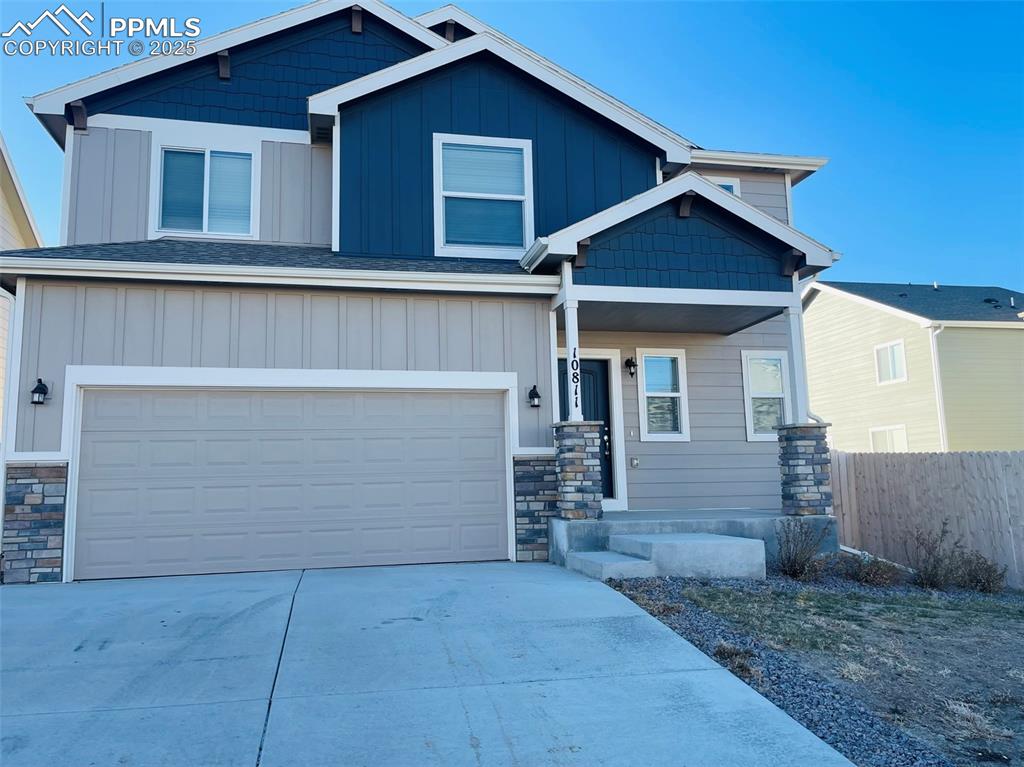 Caption: Craftsman inspired home featuring board and batten siding, concrete driveway, and an attached garage