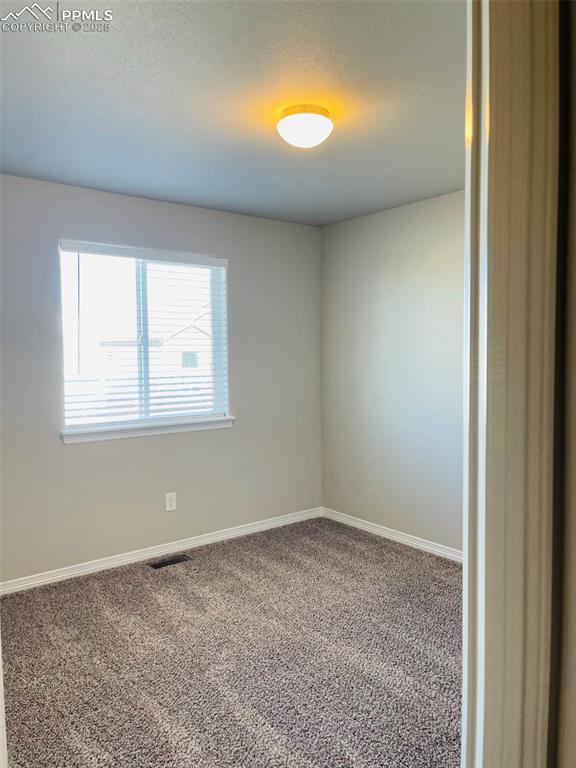 Image 14 of 19: Carpeted empty room with baseboards