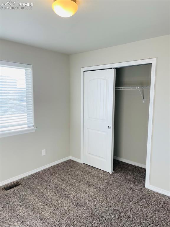 Image 15 of 19: Unfurnished bedroom featuring a closet and carpet