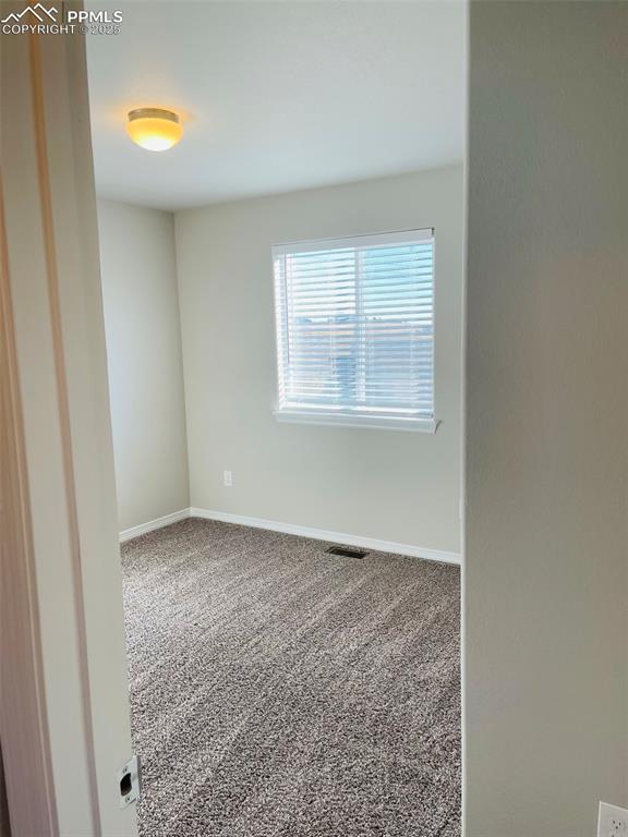 Image 18 of 19: Carpeted spare room featuring baseboards