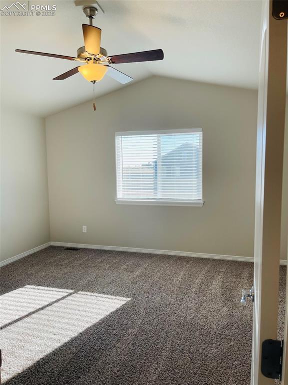 Image 8 of 19: Unfurnished room featuring carpet, lofted ceiling, and a ceiling fan