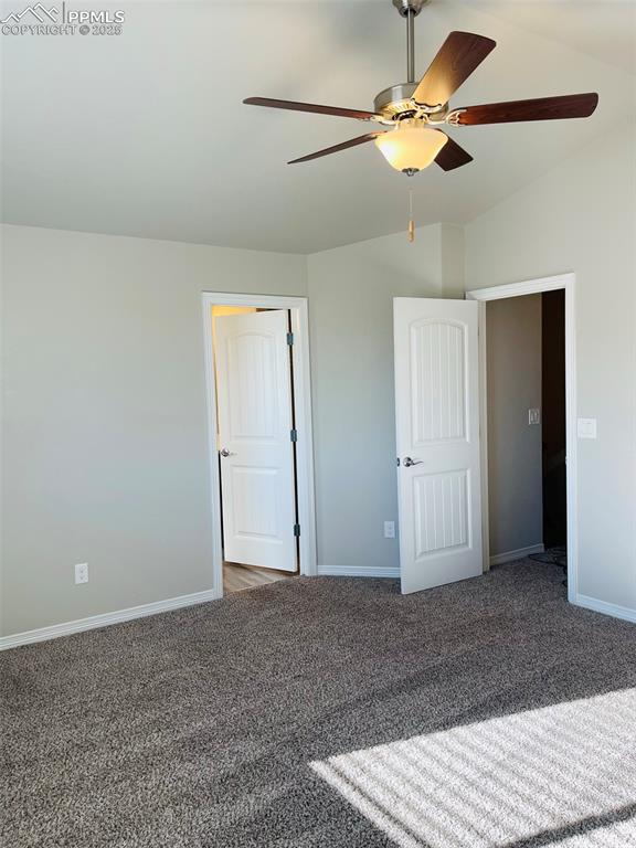 Image 9 of 19: Unfurnished bedroom with carpet and vaulted ceiling