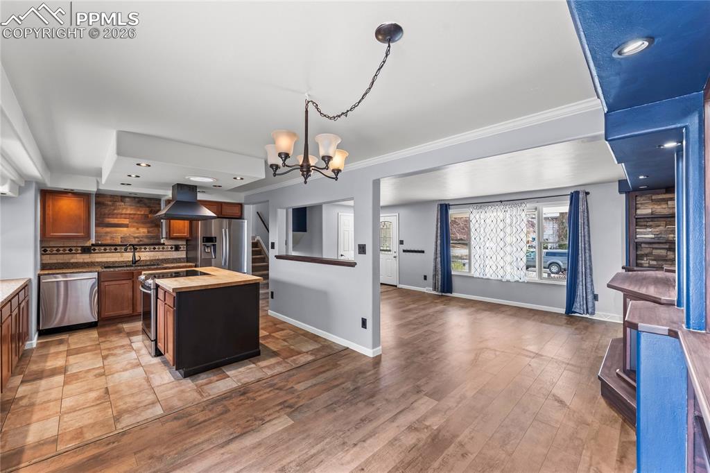 Image 11 of 40: Kitchen and dining room are open to living room