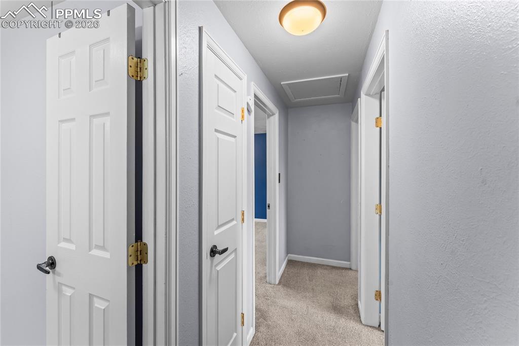 Image 15 of 40: Upper hallway leading to bathroom and bedrooms
