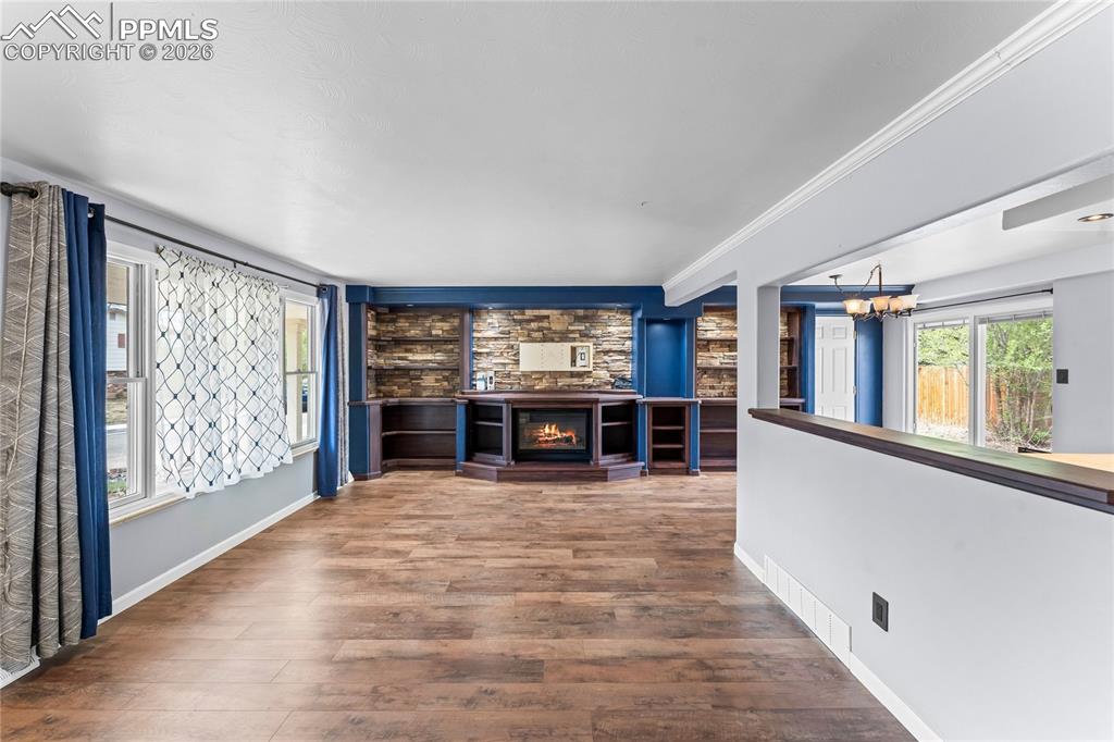 Image 8 of 40: Living room with electric fireplace and beautiful built ins