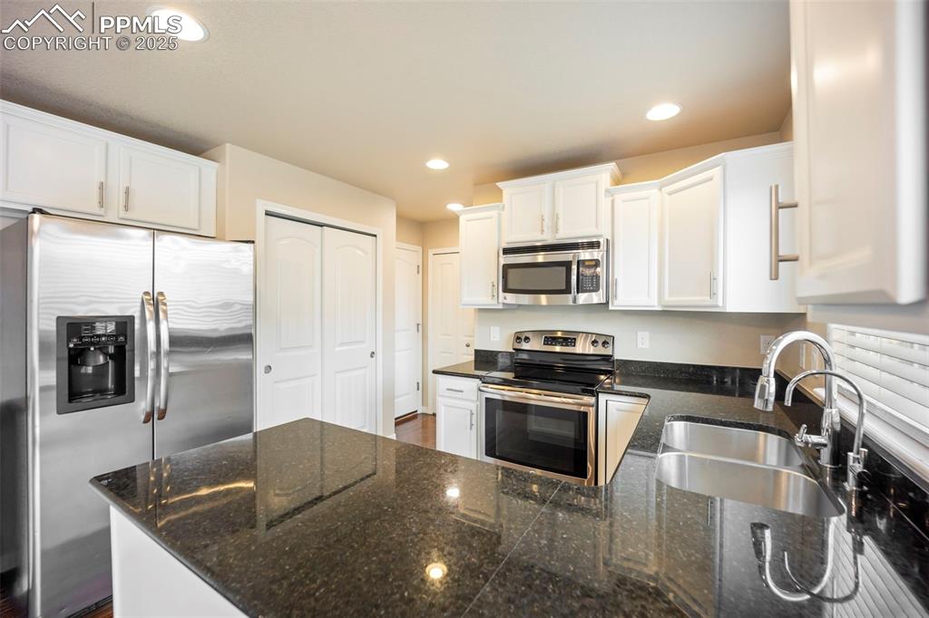 Image 11 of 39: Kitchen featuring appliances with stainless steel finishes, a peninsula, wh