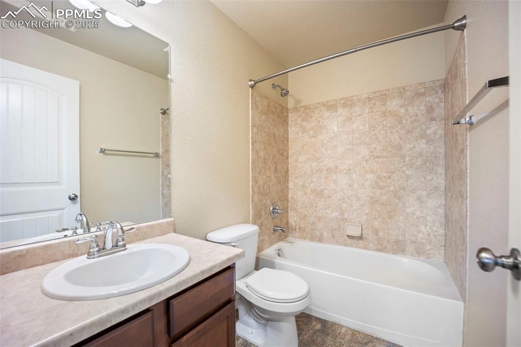 Image 15 of 39: Bathroom featuring vanity and bathing tub / shower combination