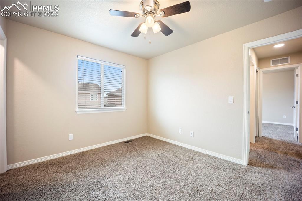 Image 28 of 39: Unfurnished room featuring carpet floors and ceiling fan