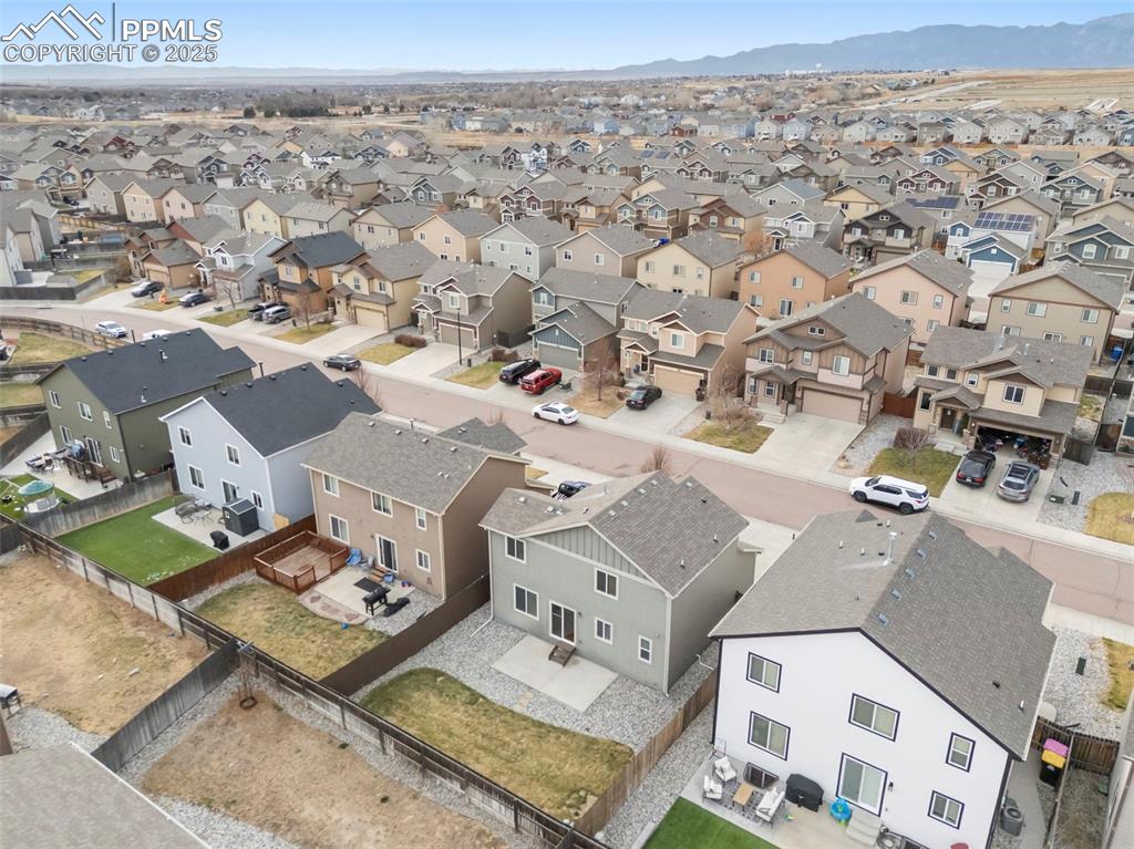 Image 39 of 39: Aerial view of residential area featuring mountains