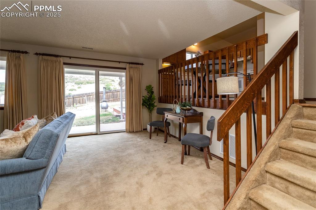 Image 17 of 46: Step down to your family room with walk-out to the backyard. 
