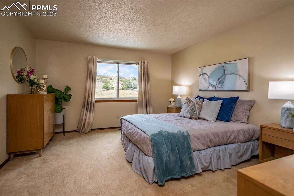 Image 24 of 46: Large master bedroom on the upper level.