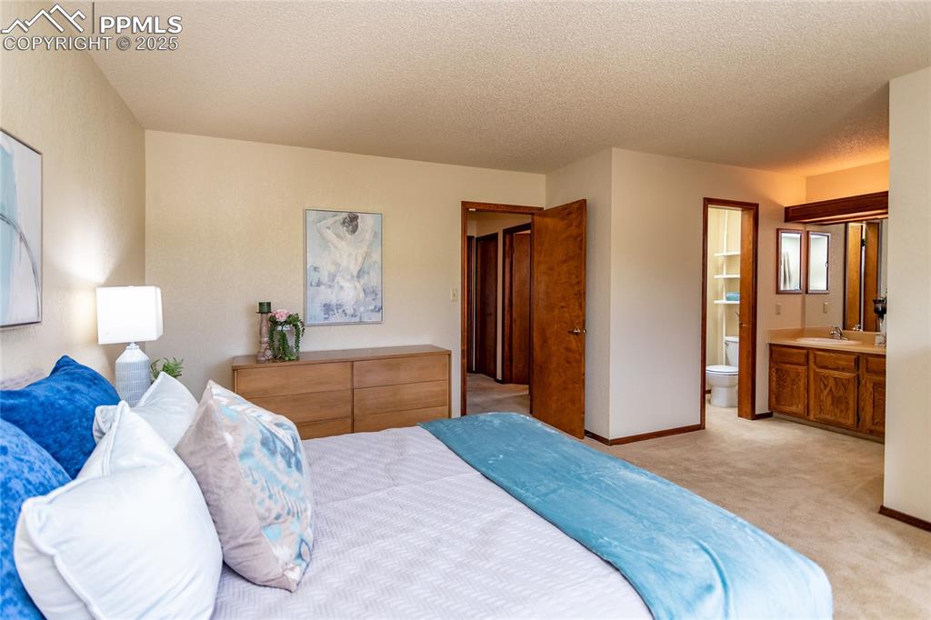 Image 26 of 46: The master bedroom also has its own dual vanity sinks, and separate toilet 