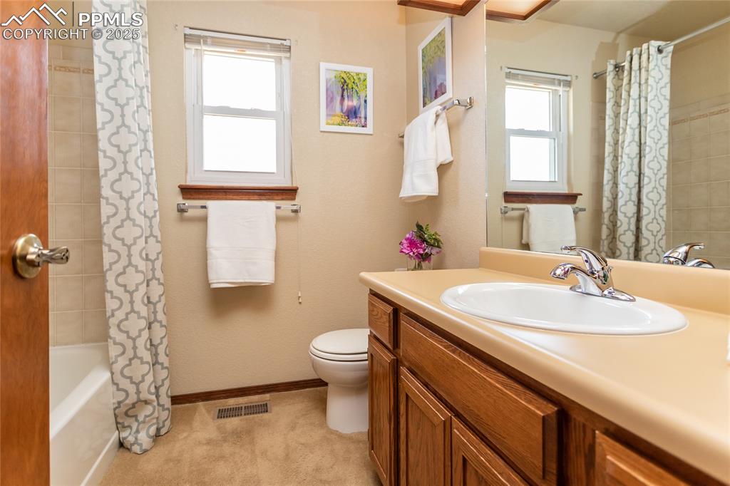 Image 32 of 46: Full bathroom with vanity and shower / tub combo.