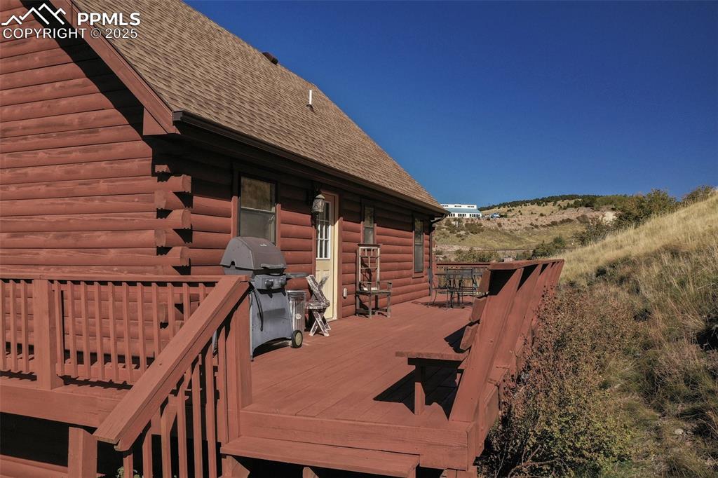 Image 19 of 28: Deck at back of home with area for grilling