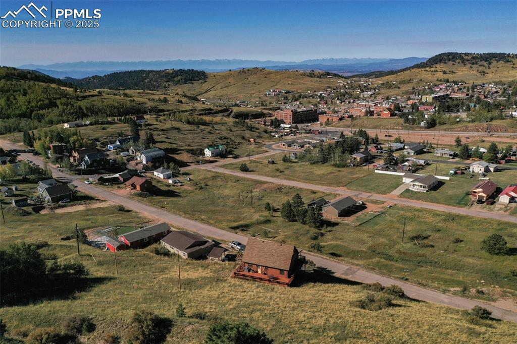 Image 27 of 28: Aerial view of property and surrounding area with a mountainous background