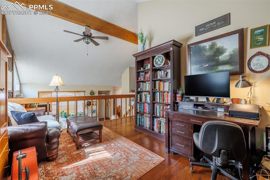 Image 14 of 16: Office area featuring ceiling fan and dark wood-type flooring