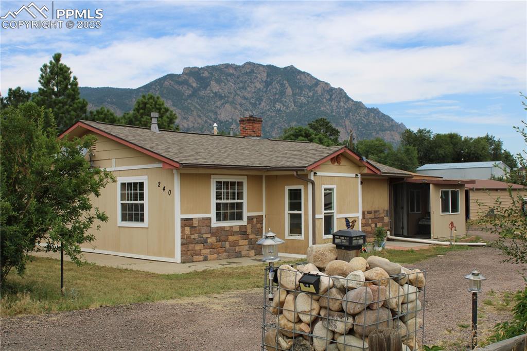 Caption: View of the home with Cheyenne Mtn. in the background