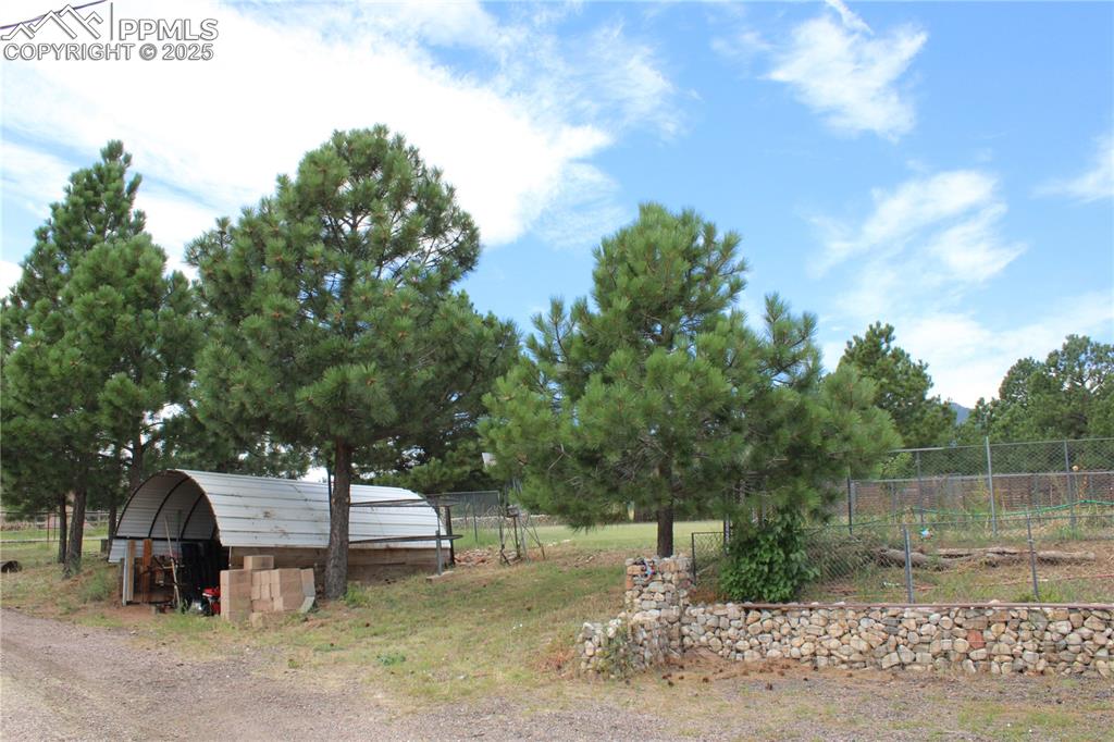 Image 10 of 41: View of yard featuring a detached carport