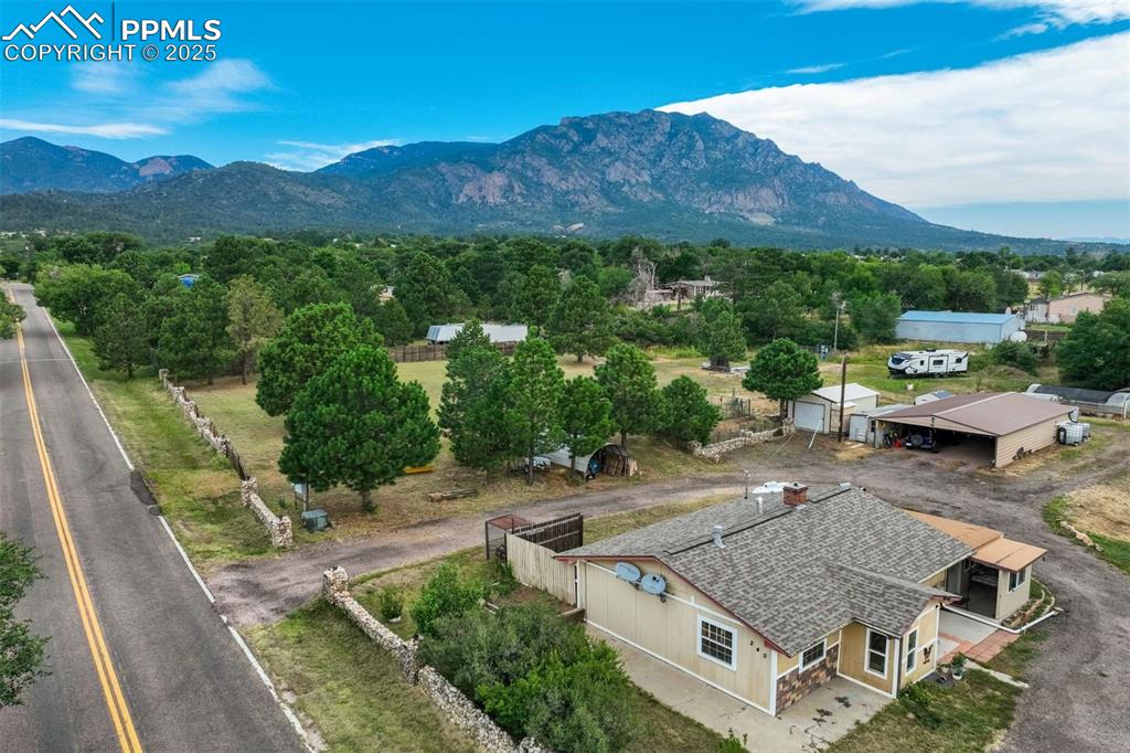 Image 2 of 41: Aerial view of property and surrounding area featuring a mountain backdrop