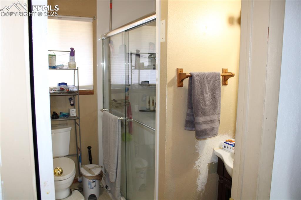 Image 21 of 41: Bathroom featuring toilet and a shower stall