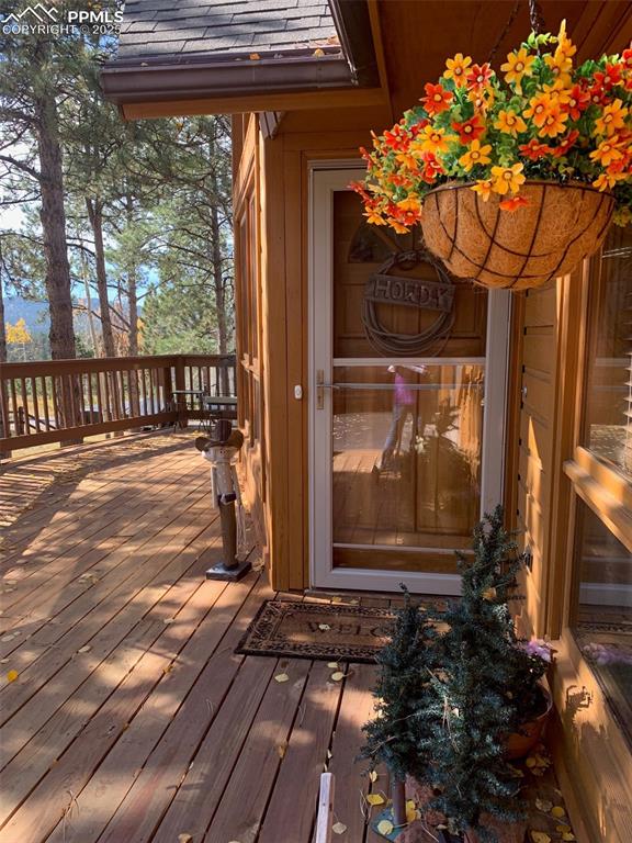 Image 7 of 43: Doorway to property with a wooden deck