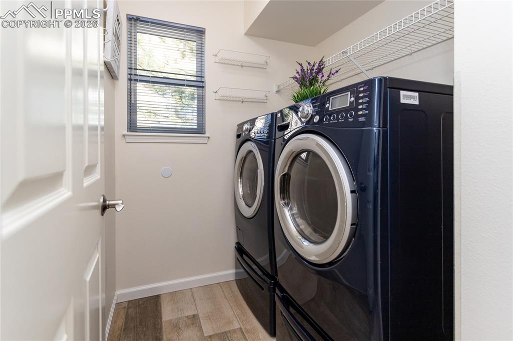 Image 22 of 50: The laundry room comes equipped with LG W/D with pedestal storage.
