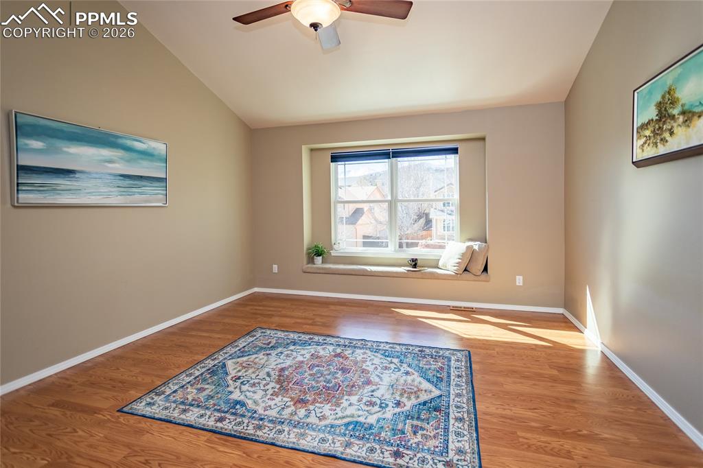 Image 24 of 50: Master bedroom with gleaming laminate flooring.